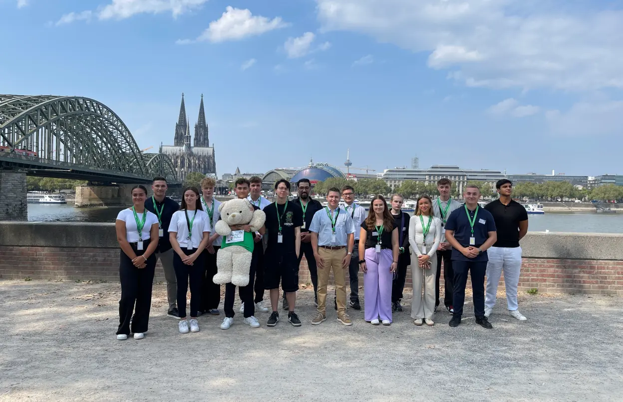 Ein Gruppenfoto der neuen Azubis mit dem Kölner Dom im Hintergrund.