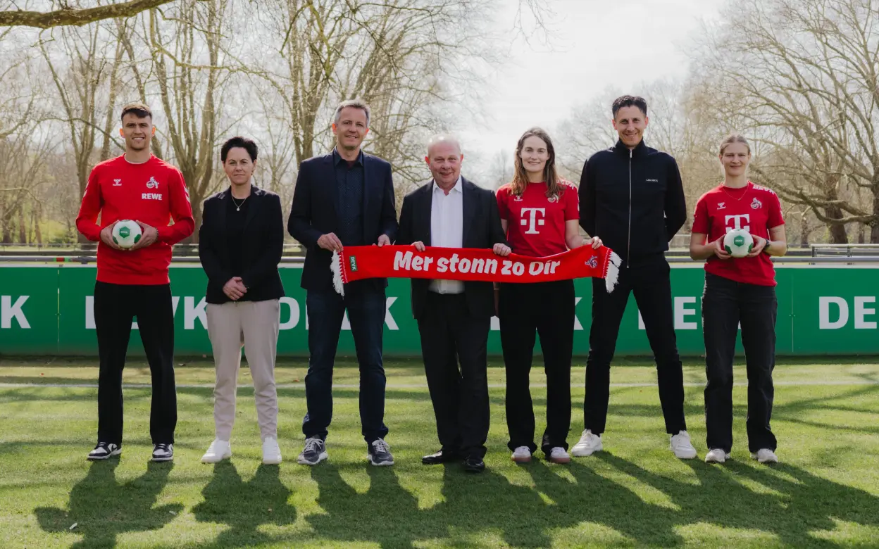 DEVK-Vorstandsvorsitzender Gottfried Rüßmann mit Funktionären und Spieler:innen des 1. FC Köln