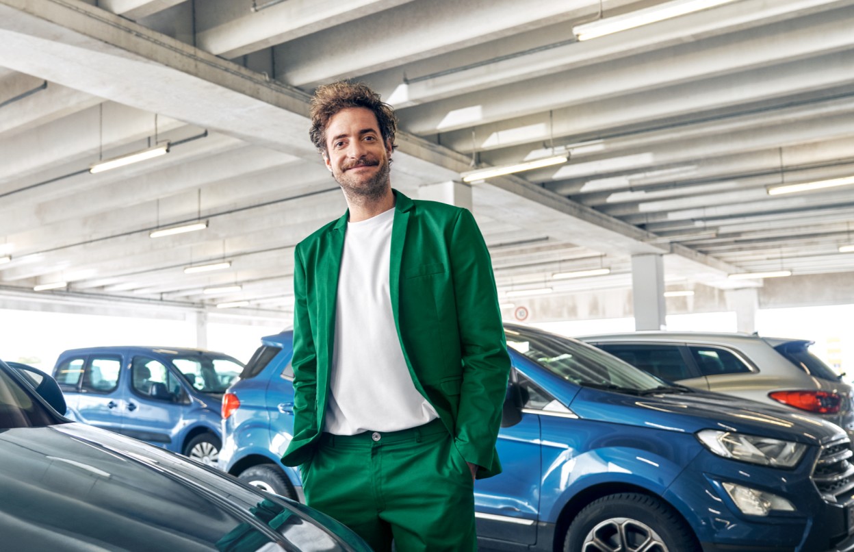 Ein Mann steht in einem Parkhaus vor Autos.