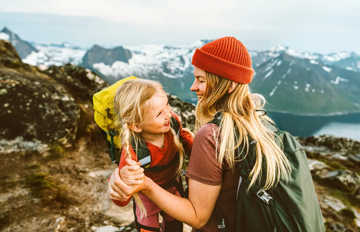 Frau wandert mit Kind auf Berg