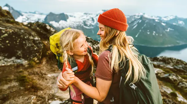 Frau wandert mit Kind auf Berg