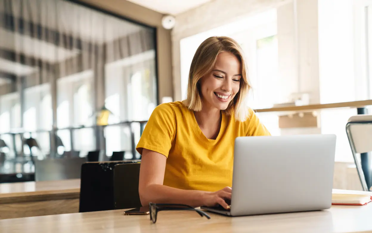 Lächelnde Frau arbeitet am Laptop