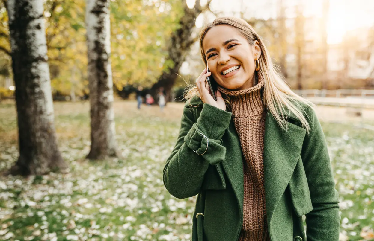 Frau telefoniert beim Spazierengehen